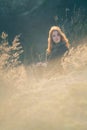 Beauty Girl Outdoors enjoying nature. Beautiful Teenage Model girl with long healthy blowing hair running on the Spring Field, Sun Royalty Free Stock Photo