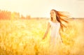 Beauty girl outdoors enjoying nature. Beautiful teenage model girl with healthy long hair in white dress Royalty Free Stock Photo