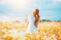 Beauty girl outdoors enjoying nature. Beautiful teenage model girl with healthy long hair in white dress Royalty Free Stock Photo