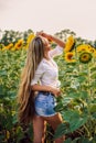 Beautiful Teenage Model girl with long healthy hair posing on the Sunflower Spring Field Royalty Free Stock Photo