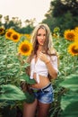 Beautiful Teenage Model girl with long healthy hair posing on the Sunflower Spring Field Royalty Free Stock Photo