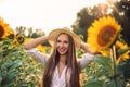 Beautiful Teenage Model girl with long healthy hair posing on the Sunflower Spring Field Royalty Free Stock Photo