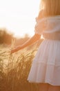 Beauty Girl Outdoors enjoying nature. Beautiful Teenage Model girl in white dress running on the Spring Field, Sun Light Royalty Free Stock Photo