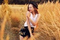 Beauty Girl Outdoors enjoying nature. Pretty Teenage Model in hat running on the Spring Field, Sun Light. Romantic Royalty Free Stock Photo