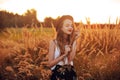 Beauty Girl Outdoors enjoying nature. Pretty Teenage Model in hat running on the Spring Field, Sun Light. Romantic Royalty Free Stock Photo