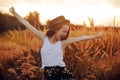 Beauty Girl Outdoors enjoying nature. Pretty Teenage Model in hat running on the Spring Field, Sun Light. Romantic Royalty Free Stock Photo