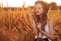 Beauty Girl Outdoors enjoying nature. Pretty Teenage Model in hat running on the Spring Field, Sun Light. Romantic young blonde g Royalty Free Stock Photo