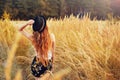 Beauty Girl Outdoors enjoying nature. Pretty Teenage Model in hat running on the Spring Field, Sun Light. Romantic Royalty Free Stock Photo