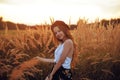 Beauty Girl Outdoors enjoying nature. Pretty Teenage Model in hat running on the Spring Field, Sun Light. Romantic Royalty Free Stock Photo