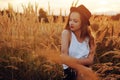 Beauty Girl Outdoors enjoying nature. Pretty Teenage Model in hat running on the Spring Field, Sun Light. Romantic Royalty Free Stock Photo