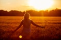 Beauty Girl Outdoors enjoying nature, raising hands. Royalty Free Stock Photo