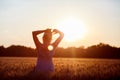 Beauty Girl Outdoors enjoying nature, raising hands. Royalty Free Stock Photo