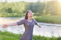 Beauty girl outdoors enjoying nature, raising hands. Dream. Royalty Free Stock Photo