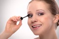 Beauty girl paints the eyelashes makeup mascara