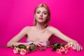 Beauty girl with pink rose. Beautiful sensual woman hold flowers, studio portrait. Royalty Free Stock Photo