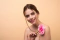 Beauty girl with pink rose. Beautiful sensual woman hold flowers, studio portrait. Royalty Free Stock Photo