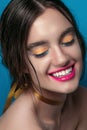 Beauty Girl Portrait with Vivid Makeup. Fashion Woman portrait close up on blue background. Bright Colors. Manicure Make up. Smoky Royalty Free Stock Photo