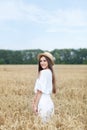 Beauty girl portrait in wheat field at sunset. Attractive young woman smiling and enjoying life. Beautiful brunette with a healthy Royalty Free Stock Photo