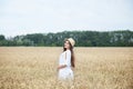 Beauty Girl portrait in wheat field at sunset. Attractive young woman smiling and enjoying life. Beautiful brunette with healthy l Royalty Free Stock Photo