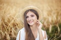 Beauty Girl portrait in wheat field at sunset. Attractive young woman smiling and enjoying life. Beautiful brunette with healthy l Royalty Free Stock Photo