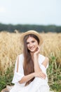 Beauty Girl portrait in wheat field at sunset. Attractive young woman smiling and enjoying life. Beautiful brunette with healthy l Royalty Free Stock Photo