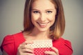 Beauty girl in red dress with gift box to birthday or Valentine's Day Royalty Free Stock Photo