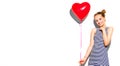 Beauty girl with red heart shaped air balloon laughing over white background. Beautiful Happy woman on birthday party, Love Royalty Free Stock Photo