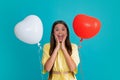 Beauty girl with red heart shaped air balloon over blue background. Beautiful teenager on birthday party, Love Royalty Free Stock Photo