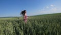 Beauty girl running on green wheat field. Freedom concept. Happy woman outdoors Royalty Free Stock Photo