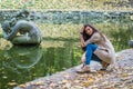 Beauty girl sitting near the pond