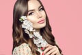 Beauty girl with spring sakura flowers. Beautiful young woman with perfect young skin. Happy model posing with blooming sakura Royalty Free Stock Photo