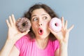 Beauty girl taking colorful donuts. Funny joyful woman with sweets, dessert. Diet, dieting concept. Junk food Royalty Free Stock Photo