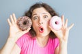 Beauty girl taking colorful donuts. Funny joyful woman with sweets, dessert. Diet, dieting concept. Junk food Royalty Free Stock Photo