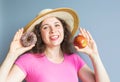 Beauty girl taking colorful donuts. Funny joyful woman with sweets, dessert. Diet, dieting concept. Junk food Royalty Free Stock Photo