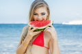 Beauty girl is wearing swimsuit eating watermelon Royalty Free Stock Photo