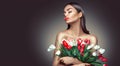 Beauty glamour girl with spring tulip flowers. Beautiful young woman with a Bunch of colorful Tulip flowers Royalty Free Stock Photo