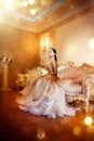 Beauty gorgeous woman in beautiful evening dress in luxurious style interior room Royalty Free Stock Photo