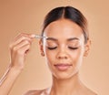 Beauty, grooming and eyebrows with woman and tweezers in studio for clean, self care and cosmetics. Facial, plucking and Royalty Free Stock Photo