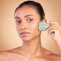 Beauty, gua sha and portrait of Indian woman for skincare, facial treatment and wellness with spa tools. Salon Royalty Free Stock Photo