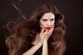 Beauty hair. Red manicure. Brunette girl with long shiny wavy ha Royalty Free Stock Photo