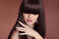 Beauty hair. Vogue Hairstyle. Fashion Manicure. Portrait of gorgeous young dark-haired woman. Sensual lips makeup. Golden polish