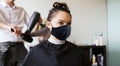 Happy woman with stylist making hairdo at salon Royalty Free Stock Photo