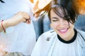 Beauty, hairstyle, treatment, hair care concept, young woman and hairdresser cutting hair at hairdressing salon. Hairdresser cutts Royalty Free Stock Photo