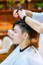 Beauty, hairstyle, treatment, hair care concept, young woman and hairdresser cutting hair at hairdressing salon. Hairdresser cutts Royalty Free Stock Photo