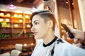 Beauty, hairstyle, treatment, hair care concept, young woman and hairdresser cutting hair at hairdressing salon. Hairdresser cuts Royalty Free Stock Photo