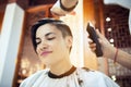 Beauty, hairstyle, treatment, hair care concept, young woman and hairdresser cutting hair at hairdressing salon. Hairdresser cutts Royalty Free Stock Photo