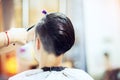 Beauty, hairstyle, treatment, hair care concept, young woman and hairdresser cutting hair at hairdressing salon. Hairdresser cutts Royalty Free Stock Photo