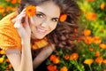 Beauty happy Romantic woman Outdoors. Beautiful Teenage girl embracing in golden marigold flowers Royalty Free Stock Photo