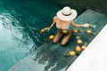 Beautiful Woman Relaxing In Swimming Pool With Pineapples. Healthy Lifestyle, Nutrition, Diet. Summer Vacation Royalty Free Stock Photo