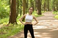 Beauty, health, fitness. Girl warming up in the park before jogging, doing exercises in nature Royalty Free Stock Photo